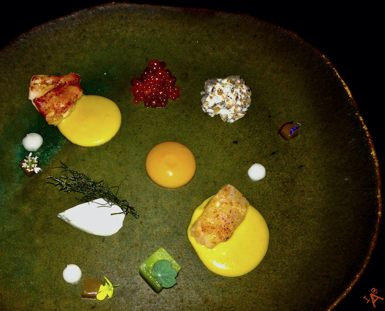 A plate of colorful food from the restaurant Alinea.