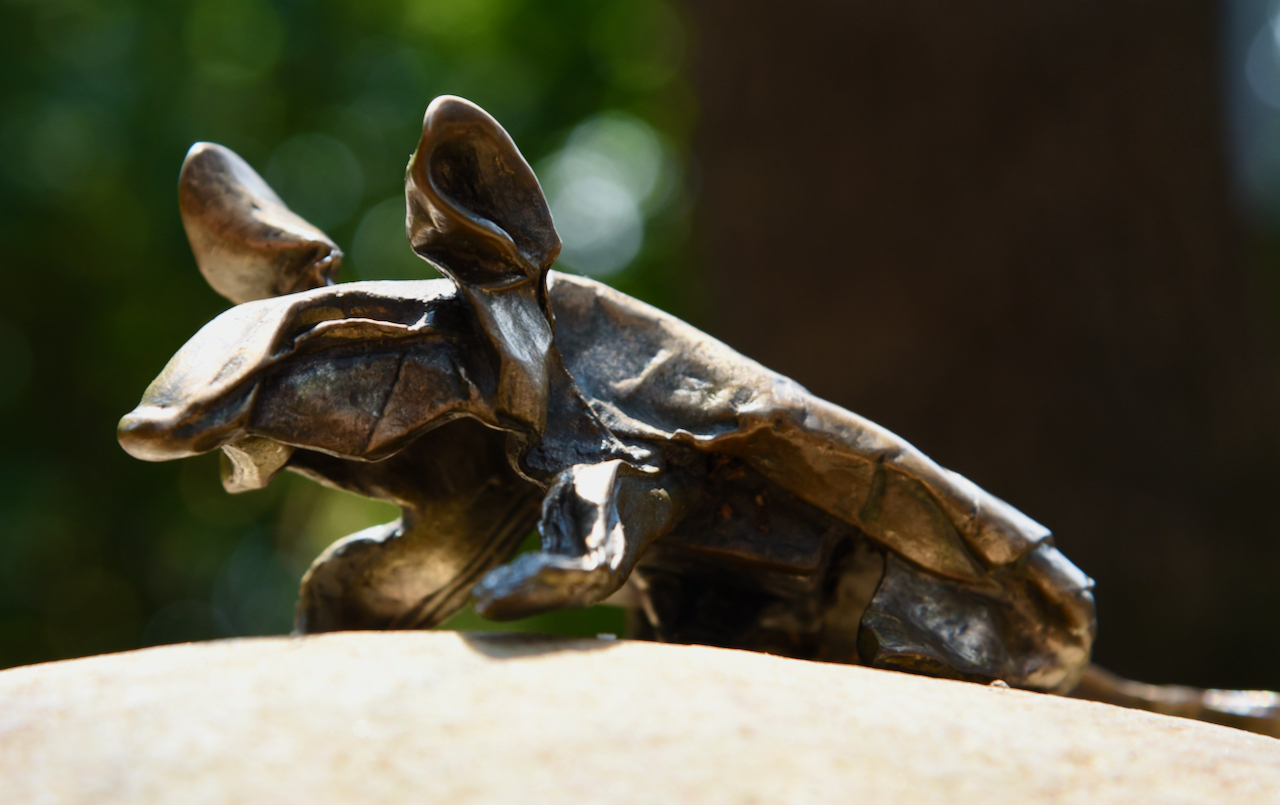 An origami mouse made out of metal.