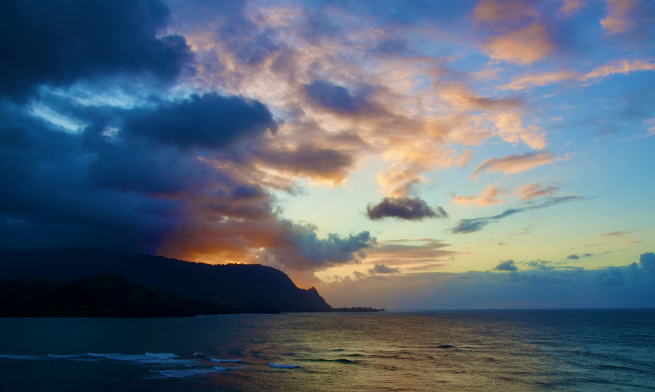 Sunset behind cliffs in Hawaii.